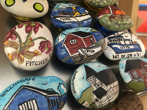 Hand painted rock magnets by Heidi Scarfone here on display at the Blue Barrel Gallery