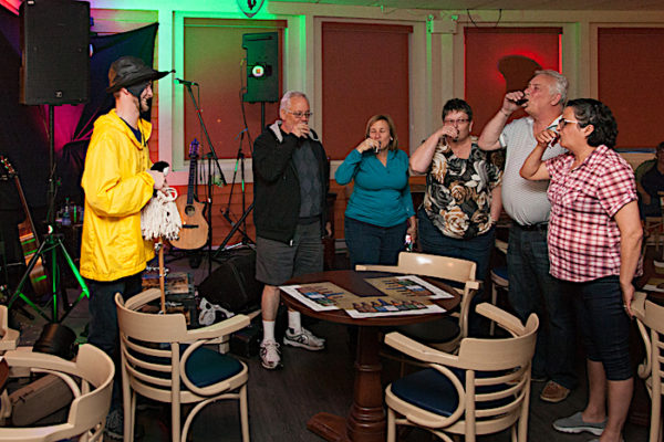 Guests are being screeched in as honorary Newfoundlanders during a screech-in ceremony at Captain's Pub.